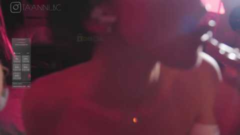 Media: A blurry video showing a person's back, possibly in a nightclub, holding a smartphone with a red light in the background.