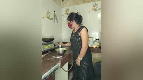 Media: Video of a woman in a dark, pinstriped dress with a red mask, stirring a pot on a brown granite counter in a small, cluttered kitchen with white tiled walls.