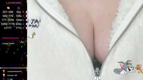 Media: Video of a woman with fair skin, wearing a white furry jacket unzipped to reveal cleavage. Background includes a chat window displaying user \"JamanDrew,\" with chat history and user profile icons.