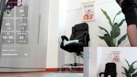 Media: Video of a modern office with a black ergonomic chair, a potted plant, and a \"Killer Whale\" poster on a white wall. A digital thermometer and calendar display the temperature and date.