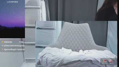 Media: Video of a plush, quilted, white pillow on a bed with a gray duvet, set against a white and gray background.