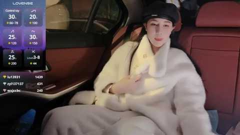 Media: Video of a young man wearing a white fur coat, black headgear, and a watch, sitting in a car with a digital display showing weather and temperature.