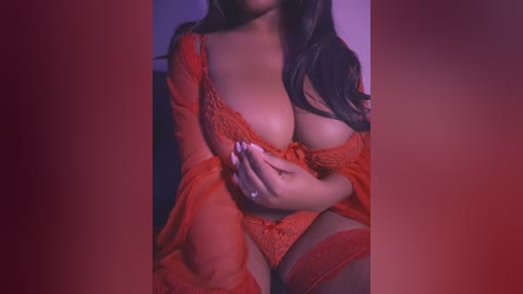 Media: Video of a curvy, dark-skinned woman with long, dark hair, wearing sheer, red lace lingerie. She's seated, with her hands clasped in front, partially covering her ample breasts. The background is a gradient of red and purple hues, creating a sensual atmosphere.