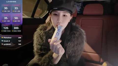 Media: Video of an Asian woman with fair skin, long black hair, wearing a black fur coat and hat, licking a cigarette, inside a car with a digital display showing stats like 30 views, 35 likes.