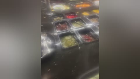 Media: A video of a messy, wet kitchen floor with various food items scattered around, including eggs, vegetables, and sauces, creating a chaotic and unorganized scene.