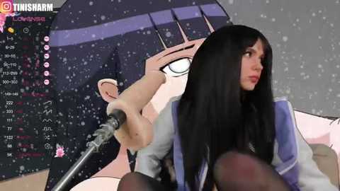 Media: A digital image featuring a woman with long black hair, wearing a blue jacket, holding a microphone, and standing in front of a snowing background with a large anime character in the background.