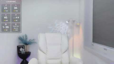 Media: A video of a minimalist room with a white leather armchair, a small black table, and a large window; a digital thermometer display shows 21 degrees Celsius.