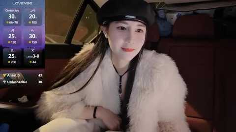 Media: Video of a young Asian woman with fair skin, long brown hair, and a black baseball cap, wearing a white fur coat, sitting in a car. Background shows car dashboard and cityscape.