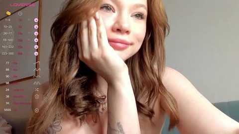 Media: A video of a fair-skinned woman with long, wavy, auburn hair, lying on her side, smiling, with a calendar and social media icons visible in the background.