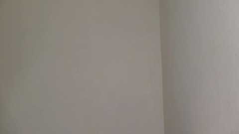 A video of a white wall with subtle, almost imperceptible color variations. The wall appears smooth and plain, with no visible textures or patterns.