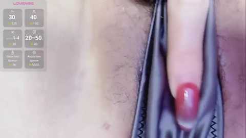 Media: Video of a close-up view of a hand pulling down black underwear, revealing pubic hair, with red nail polish, and a fitness app screen showing \"40 minutes\" and \"20-50 calories\" in the background.