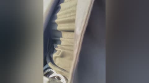 Media: A video of a partially open car door, revealing a beige car seat and a white cloth object, possibly a blanket or jacket, partially visible inside.