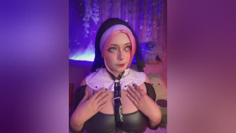 Media: Video of a fair-skinned woman with pink and white hair, dressed in a black nun outfit, holding a white choker. She stands against a purple-lit background with white curtains.