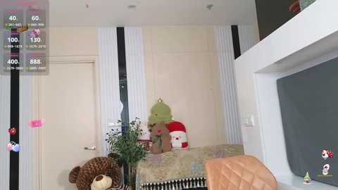 Media: A video of a cozy, minimalist room with a plush bear and a green lamp on a white bed, surrounded by beige and black striped wallpaper, and a TV in the background.