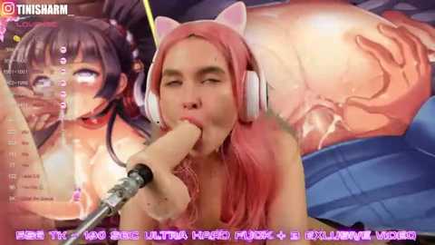 A digital anime-style image featuring a young woman with pink hair and cat ears, performing oral sex on a large, erect penis. Background shows a live-stream chat window.