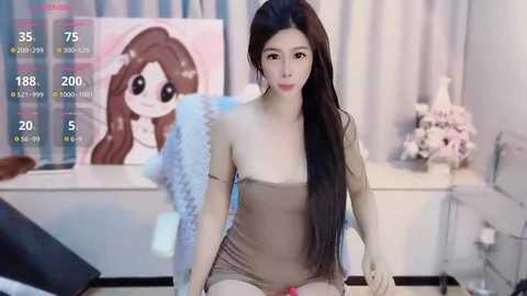 Media: Video of an East Asian woman with long black hair, wearing a tight beige dress, sitting in a modern room with a TV screen displaying her stats.