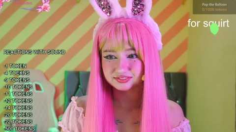 Media: A video of an Asian woman with long pink hair wearing bunny ears, smiling. Background features neon-striped walls. Text overlay shows reactions with sound and number of tokens.