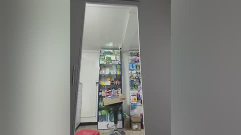 Media: Video of a messy, cluttered room with a large mirror reflecting a chaotic arrangement of boxes, bottles, and bags, suggesting disorganization and potential hoarding.