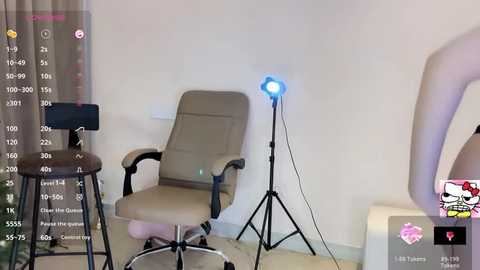 Video of a minimalist, beige office chair with a blue light, set against a plain white wall, accompanied by a black stool and a small, white table.