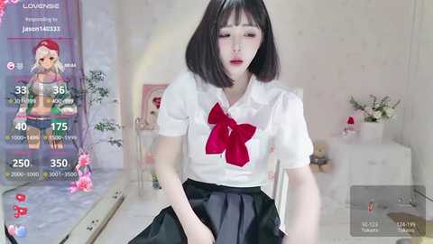 Media: A video of an East Asian woman with short black hair, wearing a white blouse with a large red bow and a black skirt, in a virtual reality environment.