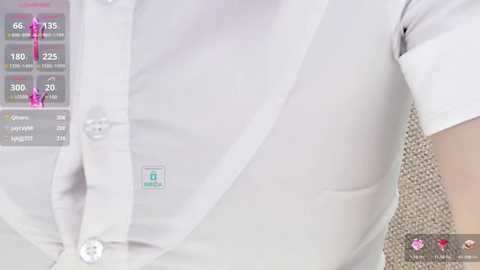 Media: A close-up video of a woman's white button-up shirt with a small logo, displaying a digital overlay with health metrics and a heart icon. The background features a textured, beige fabric.