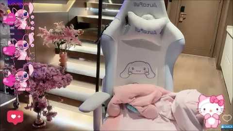 A video of a plush Hello Kitty gaming chair with a Hello Kitty pillow, set in a modern room with a purple flower arrangement, pink heart stickers, and a virtual pink cat overlay.