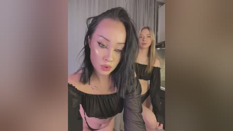 Media: A video featuring a young Asian woman with black hair, wearing a black off-shoulder crop top, standing in front of a mirror.