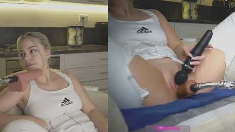 Video of a blonde woman in a white Adidas tank top, using a black vibrator on her shaved genitals, in a modern kitchen.