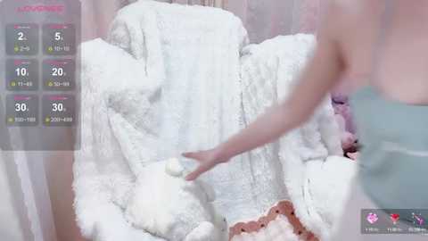 Video of a woman in a white dress, petting a fluffy white cat, with a digital pet care app interface overlay showing feeding and playtime stats.