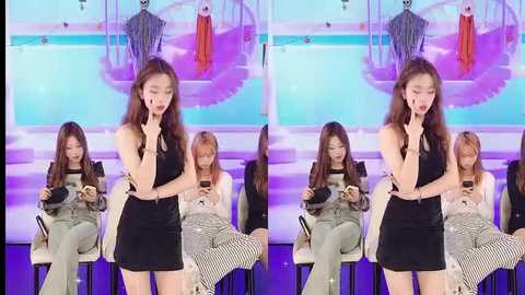 Media: A split-screen video features two Asian women in black dresses, seated on chairs, focused on their smartphones. The background displays a stage with a blue pool and a swing, creating a modern, stylish setting.