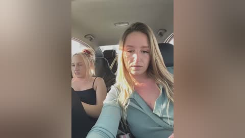 Media: Video of a woman in a teal top driving a car, with a blonde woman in a black top in the passenger seat.