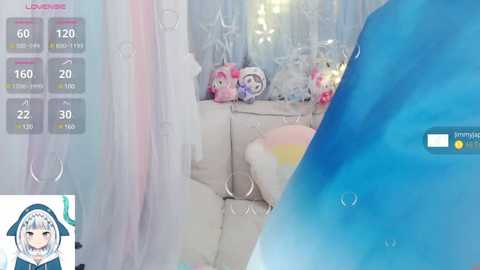 Media: A video captures a child's playful, pastel-themed bedroom with a blue dolphin toy and a plush, star-adorned blanket. The background features a pink and white curtain, with digital game stats displayed on the left.