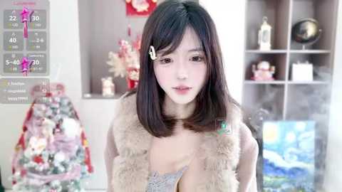 Media: A video of an East Asian woman with straight black hair, light skin, and a slender build, wearing a beige fur vest, standing in a brightly lit room with bookshelves and decorations in the background.