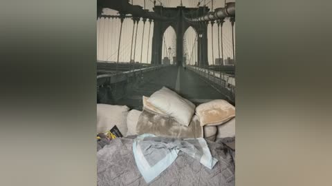 Media: Video of an airplane cabin interior showing a messy bed with pillows, blankets, and a book, against a background of dark, industrial-style seats and archways.