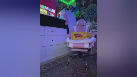 Media: Video of a pink and white gaming chair with a \"Sonic the Hedgehog\" pillow, set in a brightly lit, themed room with neon lights and a vibrant mural.