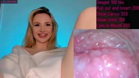 Media: A video featuring a smiling, fair-skinned blonde woman in a white robe, with an inset close-up of her pink, moist, inner vaginal tissue. The background is a blue gradient.