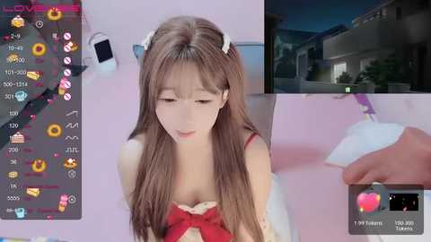 Media: Video of an Asian woman with long brown hair in a red dress, looking down, overlaid with digital hearts and emojis.