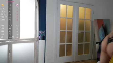 Media: Video of a modern kitchen with white cabinets, glass-paneled doors, and a white refrigerator, featuring a digital display showing a weather forecast.