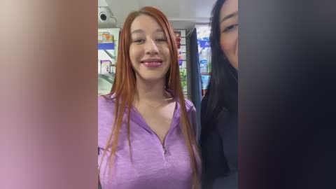 Media: A video of two Asian women standing in a convenience store. One woman with long red hair, wearing a purple shirt, smiles at the camera, while the other, partially visible, has long black hair and is wearing a black shirt.