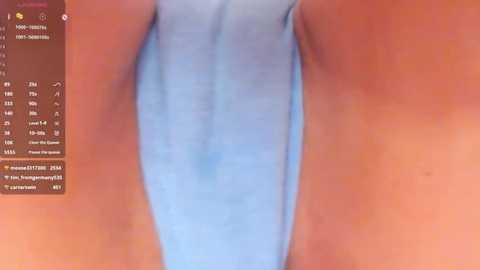 Media: Video of a close-up of a woman's crotch area in light blue panties, with a side view of her thighs and lower abdomen. The background shows a text menu with options.