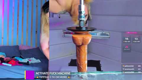 Media: Video of a woman with blonde hair, wearing a black top, using a large, realistic, tan dildo on a wooden base in a modern, minimalistic room with purple and blue lighting.