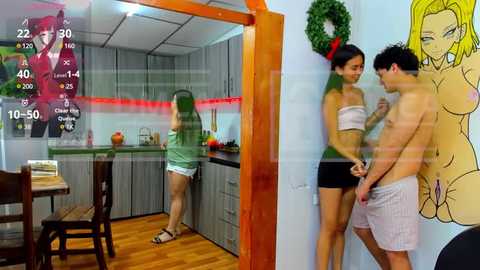 Media: A candid video of two young Asian women in a modern kitchen, one topless, the other in a strapless top, discussing a man through a glass door.