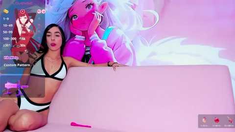 Media: Video of a Latina woman with long black hair, wearing a white bikini, sitting on a pink couch. She leans against a large, blank, white canvas. The background includes a digital display of a custom pattern and a chat interface.