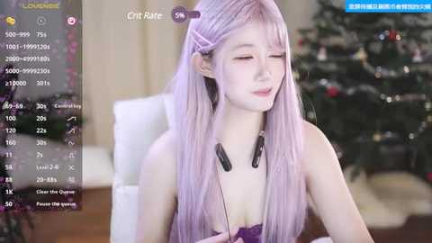 Media: Video of a pale-skinned, slender young woman with long, lavender hair, wearing a purple top, headphones, and a serene expression, seated indoors with a blurred Christmas tree in the background.