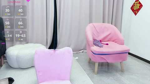 Media: A video of a pink, plush armchair with a purple blanket, in a room with beige curtains, white floor, and a white bean bag.