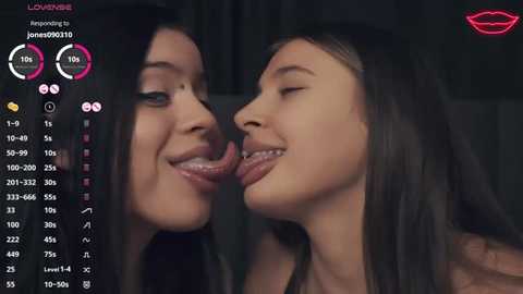 Media: Video of two smiling women with long hair, tongues touching, against a dark background. Live streaming interface on the left with user stats and hearts.