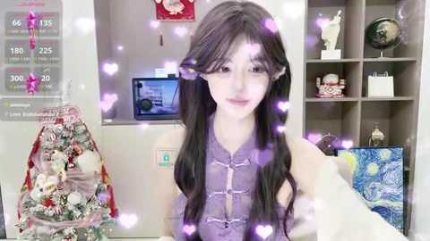 Media: A video of a young Asian woman with long, dark hair, wearing a purple lace top, in a cozy room with Christmas decorations, a globe, and heart filters.