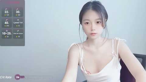 Media: A video of an Asian woman with light skin and black hair, wearing a white camisole, sitting indoors against a plain gray wall. A digital temperature display with 20\u00b0C and 40% humidity is visible in the background.