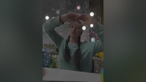 Media: A video captures a young woman with long braided hair, wearing a green sweater, adjusting her glasses in front of a fogged-up window, surrounded by blurred, colorful objects.