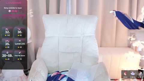 Media: Video of a plush, white, tufted armchair in a softly lit room, with a virtual overlay displaying temperature and humidity levels.